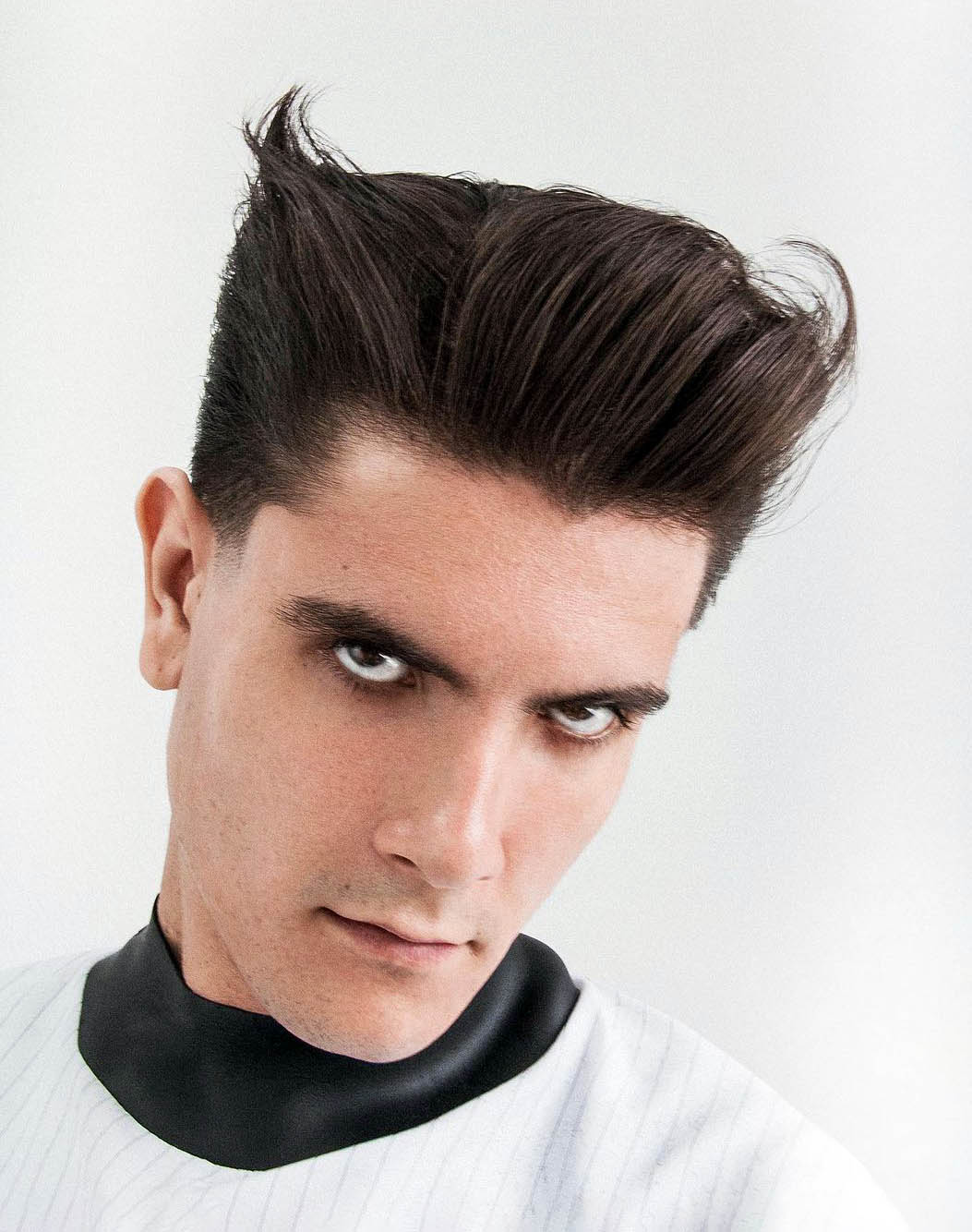 Image of Slicked back with side part long brushed back hairstyle