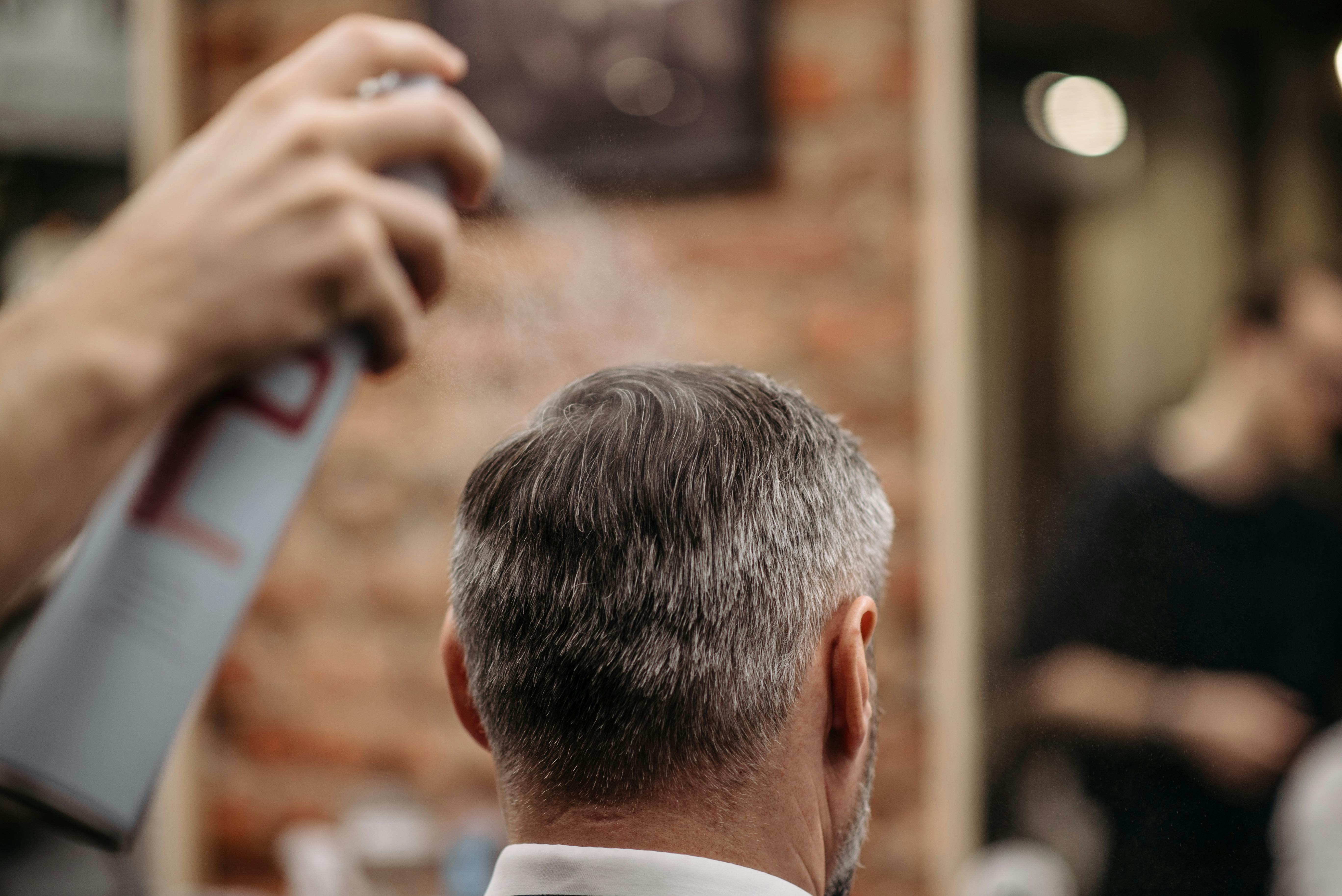 Grooming tips # 6. Less the chemicals the better. Here illustrated with a man using just a little hairspray