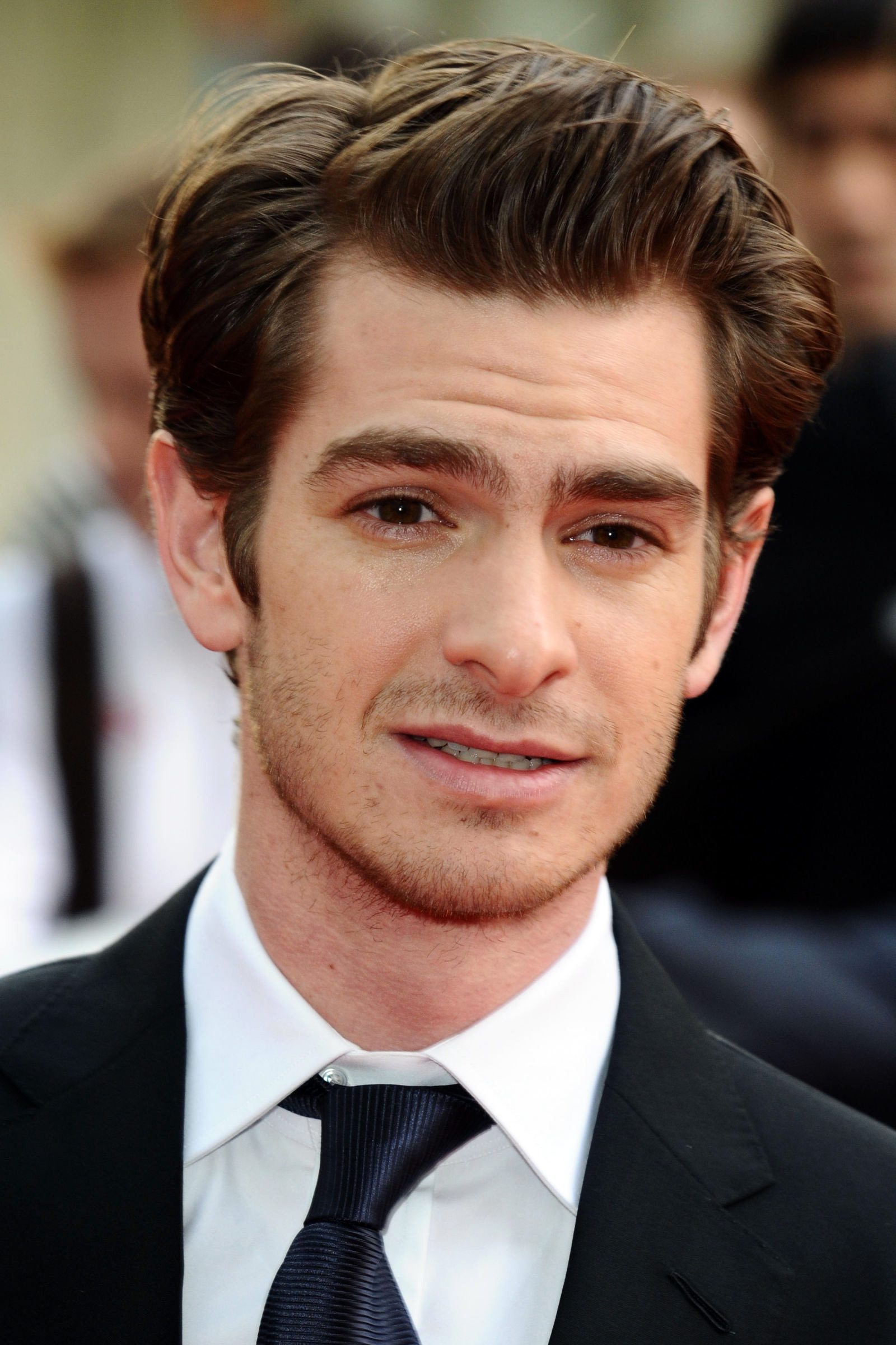 Andrew Garfield medium length side part with hair brushed back