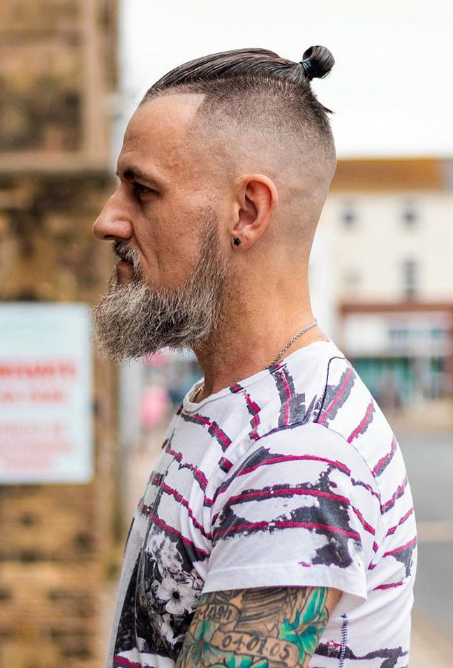 Brunette Man With Mustache And Beard With Top Knot Hairstyle Looking Away  Wearing Blue Shirt Stock Photo - Download Image Now - iStock